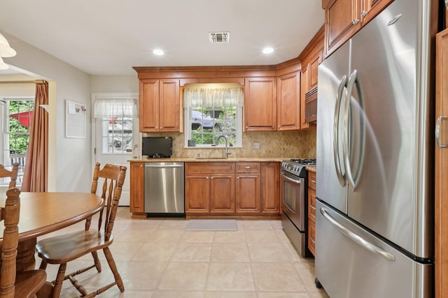 3 Hoyt Ct, Stony Point, NY 10980 - kitchen with appliances with stainless steel finishes, brown cabinets, decorative backsplash, light stone countertops, and recessed lighting