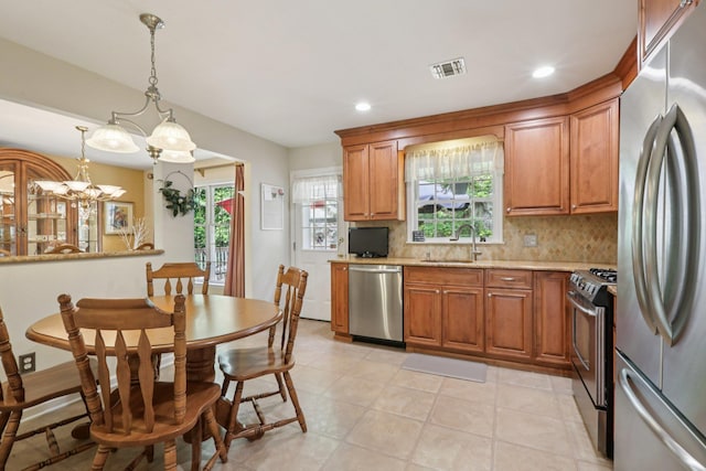 3 Hoyt Ct, Stony Point, NY 10980 - kitchen featuring stainless steel appliances, brown cabinetry, tasteful backsplash, hanging light fixtures, and recessed lighting