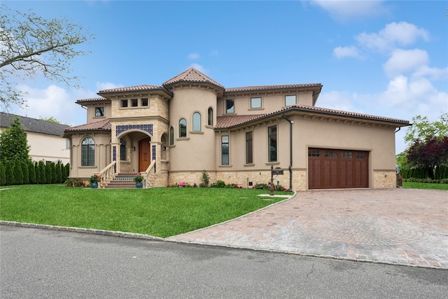 1190 Harbor Rd, Hewlett Harbor, NY 11557 - mediterranean / spanish-style house featuring stucco siding, decorative driveway, a front yard, and stone siding