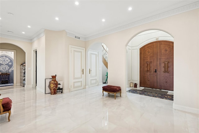 1190 Harbor Rd, Hewlett Harbor, NY 11557 - entrance foyer with arched walkways, ornamental molding, recessed lighting, and marble tiled floors