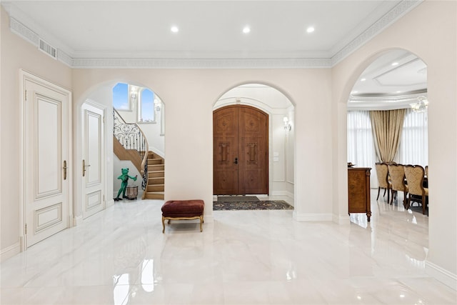1190 Harbor Rd, Hewlett Harbor, NY 11557 - foyer featuring arched walkways, crown molding, stairway, and marble finish flooring