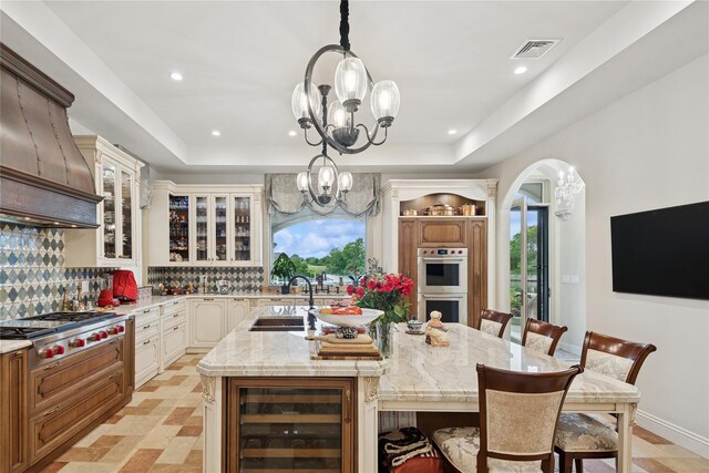 1190 Harbor Rd, Hewlett Harbor, NY 11557 - kitchen featuring stainless steel appliances, wine cooler, a breakfast bar, a large island, and recessed lighting