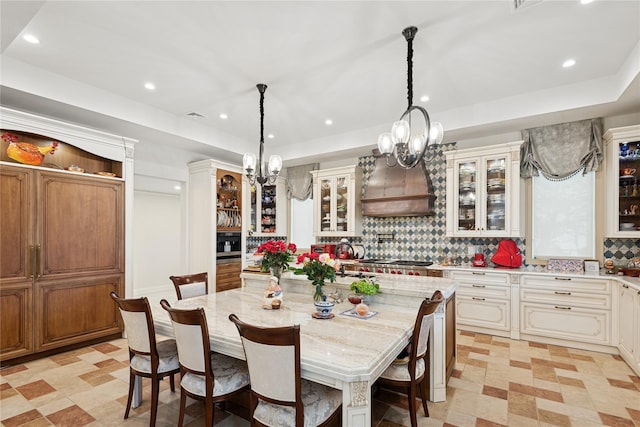 1190 Harbor Rd, Hewlett Harbor, NY 11557 - dining area featuring a chandelier, light floors, recessed lighting, and a tray ceiling