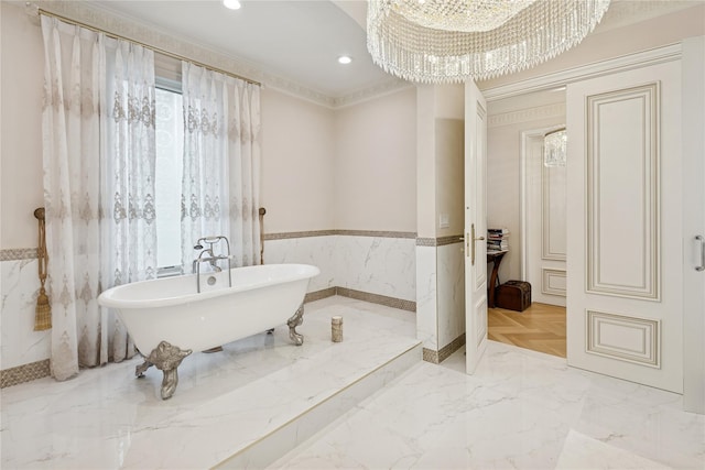 1190 Harbor Rd, Hewlett Harbor, NY 11557 - bathroom with a wainscoted wall, a soaking tub, a chandelier, recessed lighting, and marble tiled floors