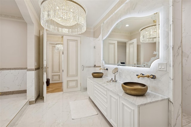 1190 Harbor Rd, Hewlett Harbor, NY 11557 - bathroom featuring a chandelier, crown molding, double vanity, and marble finish flooring