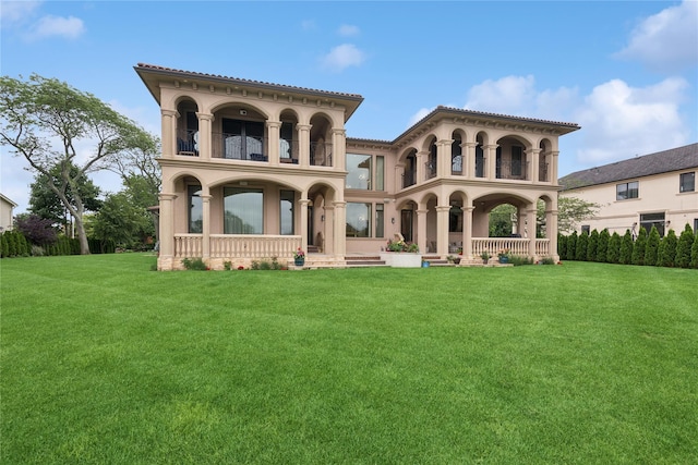 1190 Harbor Rd, Hewlett Harbor, NY 11557 - back of house with a balcony, covered porch, a yard, and stucco siding
