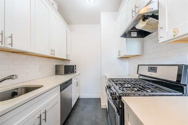 6109 39th Ave Unit J3, Woodside, NY 11377 - kitchen with appliances with stainless steel finishes, under cabinet range hood, white cabinetry, decorative backsplash, and light countertops