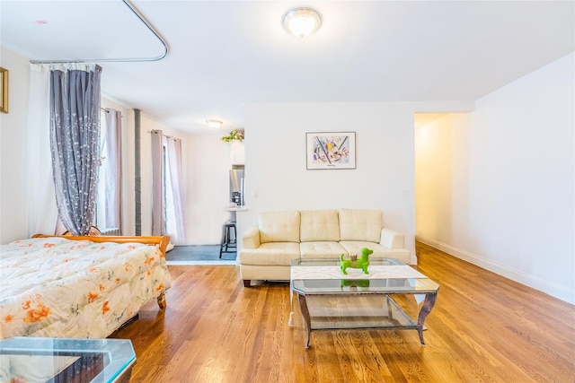 6109 39th Ave Unit J3, Woodside, NY 11377 - bedroom with wood finished floors and stainless steel fridge