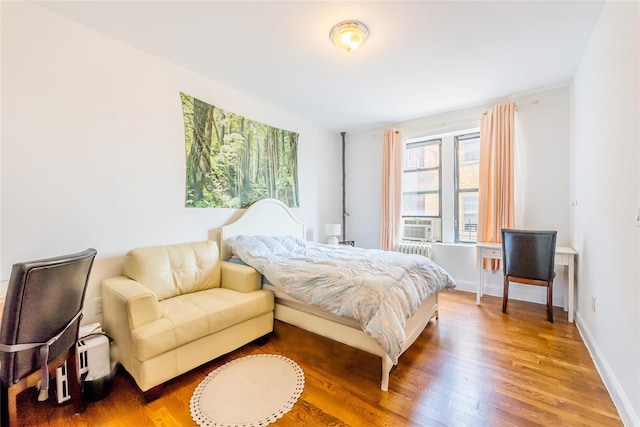 6109 39th Ave Unit J3, Woodside, NY 11377 - bedroom with wood finished floors and radiator heating unit