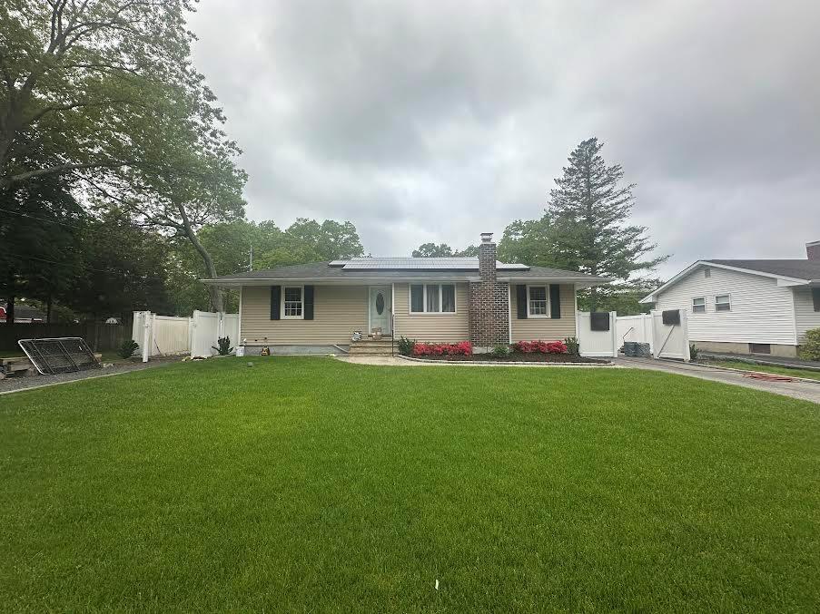 62 S Howell Ave, Centereach, NY 11720 - ranch-style house with a chimney and a gate