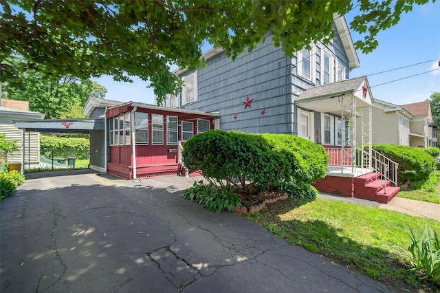 16 King St, Port Jervis, NY 12771 - view of property exterior with an attached carport, driveway, and a sunroom