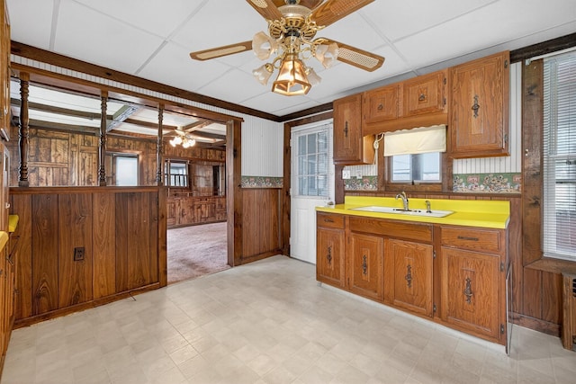 16 King St, Port Jervis, NY 12771 - kitchen with light floors, healthy amount of natural light, wood walls, brown cabinets, and wainscoting