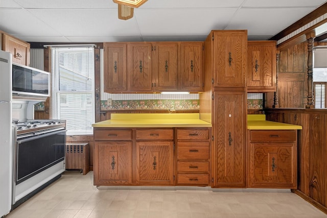 16 King St, Port Jervis, NY 12771 - kitchen with stainless steel range oven, radiator heating unit, and healthy amount of natural light