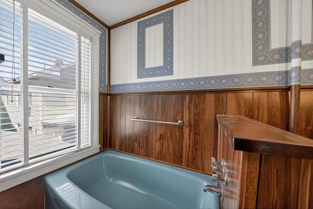16 King St, Port Jervis, NY 12771 - bathroom with wallpapered walls, healthy amount of natural light, a bath, a wainscoted wall, and ornamental molding