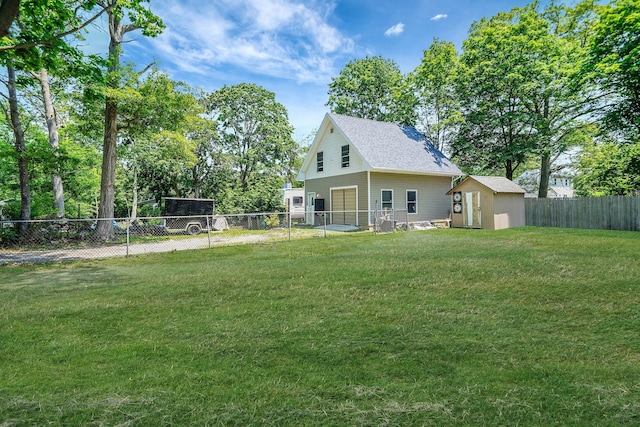 27 Dana Ave, Mastic, NY 11950 - back of property featuring a garage, a fenced backyard, a shed, and a shingled roof