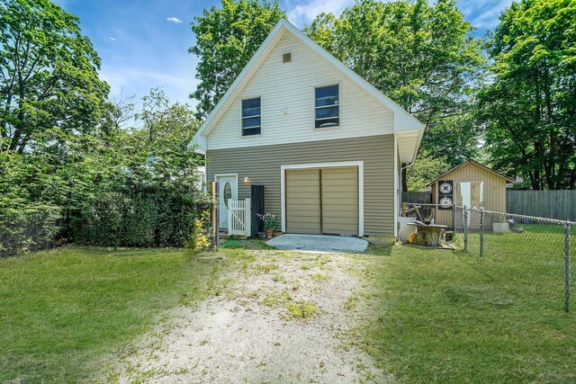 27 Dana Ave, Mastic, NY 11950 - view of front of house with an outdoor structure and driveway