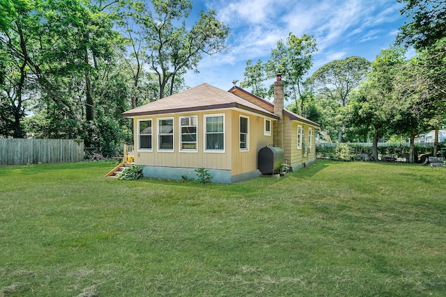 27 Dana Ave, Mastic, NY 11950 - view of property exterior with oil tank and a chimney