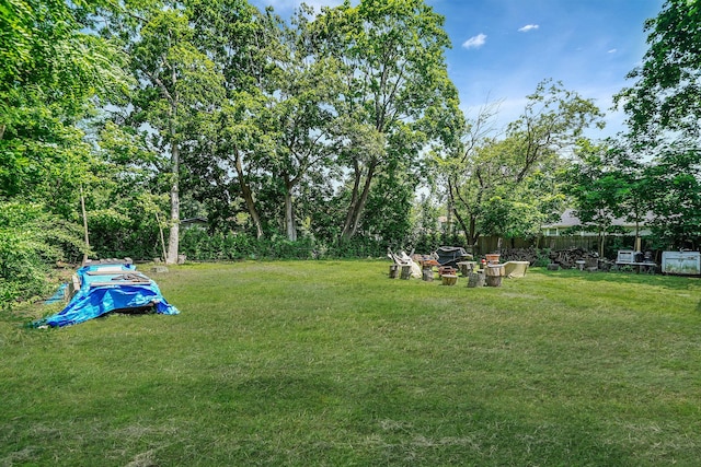 27 Dana Ave, Mastic, NY 11950 - view of green lawn featuring a fire pit