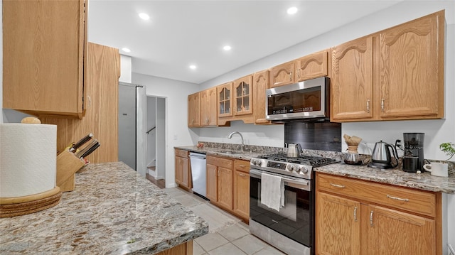 7 Kings Ln, Montrose, NY 10548 - kitchen featuring stainless steel appliances, light stone counters, recessed lighting, glass insert cabinets, and light tile patterned floors
