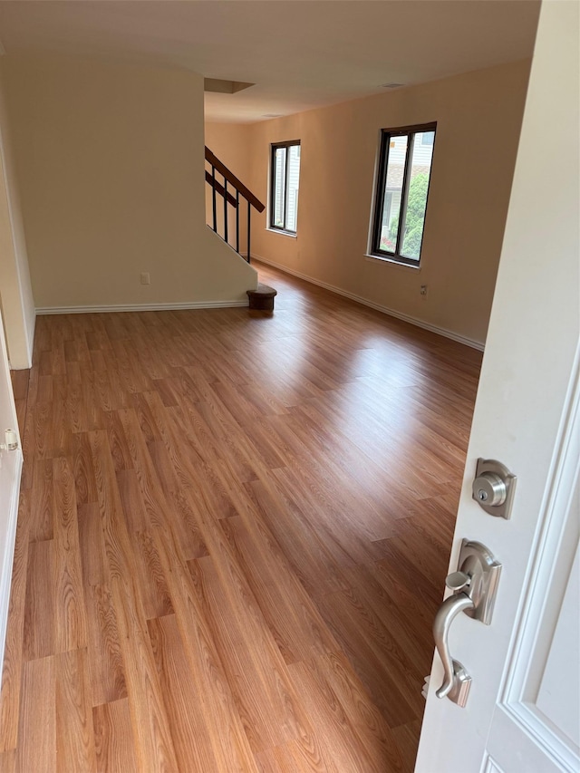 1012 Skyline Dr, Coram, NY 11727 - empty room with stairs and wood finished floors