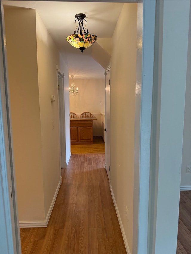 1012 Skyline Dr, Coram, NY 11727 - hall featuring wood finished floors and a chandelier
