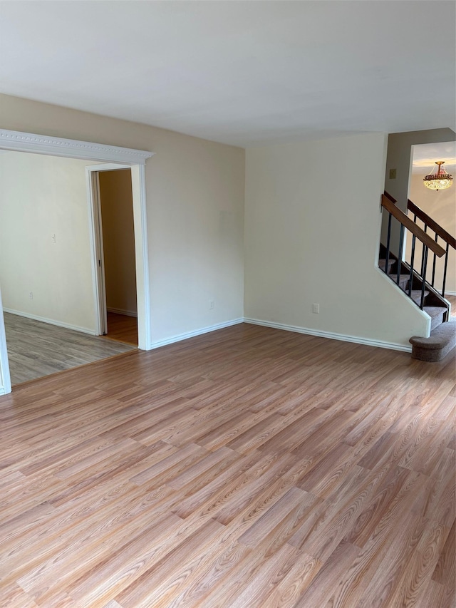 1012 Skyline Dr, Coram, NY 11727 - empty room featuring wood finished floors and stairs