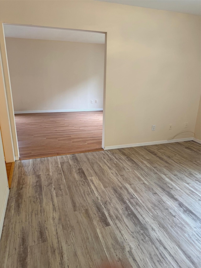 1012 Skyline Dr, Coram, NY 11727 - unfurnished room with wood finished floors and baseboards