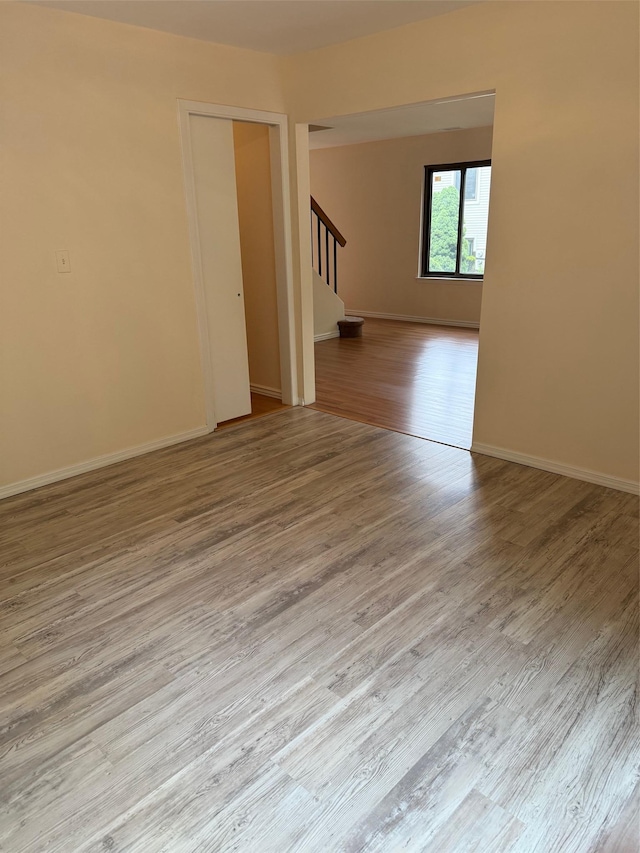 1012 Skyline Dr, Coram, NY 11727 - unfurnished room with stairway and wood finished floors