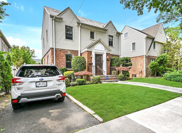 33-50 210th St, Bayside, NY 11361 - view of front of house with brick siding and a front yard