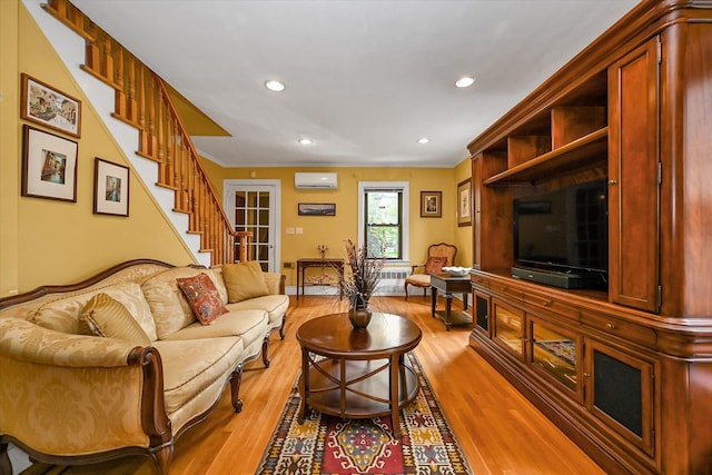 33-50 210th St, Bayside, NY 11361 - living room featuring a wall unit AC, light wood-style flooring, recessed lighting, and stairs
