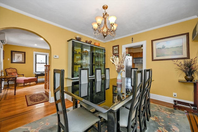 33-50 210th St, Bayside, NY 11361 - dining space with arched walkways, hardwood / wood-style floors, a chandelier, an AC wall unit, and ornamental molding