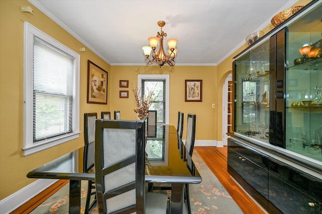 33-50 210th St, Bayside, NY 11361 - dining room featuring a chandelier, arched walkways, ornamental molding, and wood finished floors