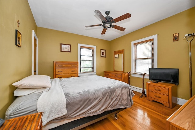 33-50 210th St, Bayside, NY 11361 - bedroom featuring wood finished floors, multiple windows, and ceiling fan