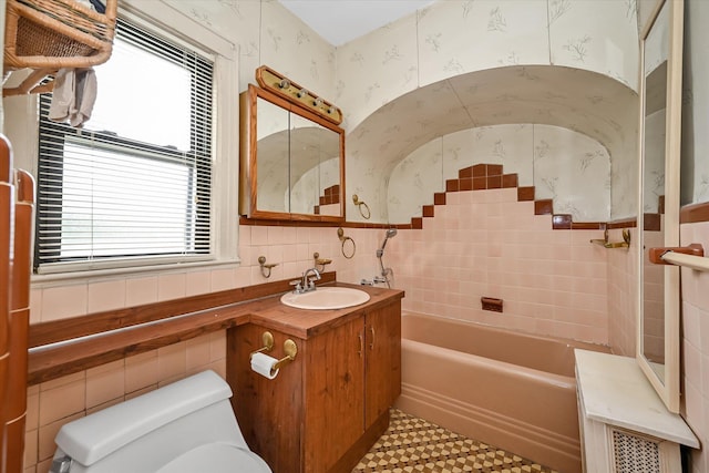 33-50 210th St, Bayside, NY 11361 - full bathroom with tile walls, vanity, a tub, and wallpapered walls
