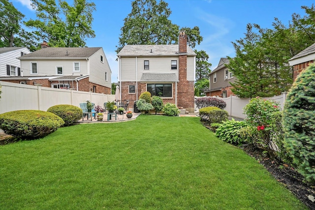 33-50 210th St, Bayside, NY 11361 - back of property featuring brick siding, a chimney, a patio area, and a fenced backyard