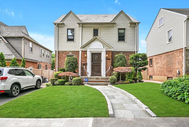 33-50 210th St, Bayside, NY 11361 - view of front of home featuring brick siding and a front lawn