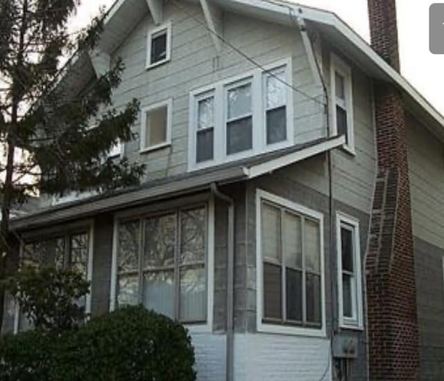 49 Waldo Ave, East Rockaway, NY 11518 - view of side of home with a chimney