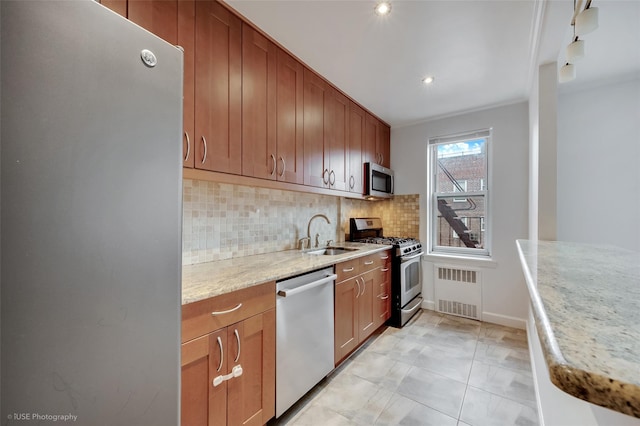 39-60 52nd St Unit 4F, Woodside, NY 11377 - kitchen featuring appliances with stainless steel finishes, backsplash, radiator heating unit, light stone countertops, and recessed lighting