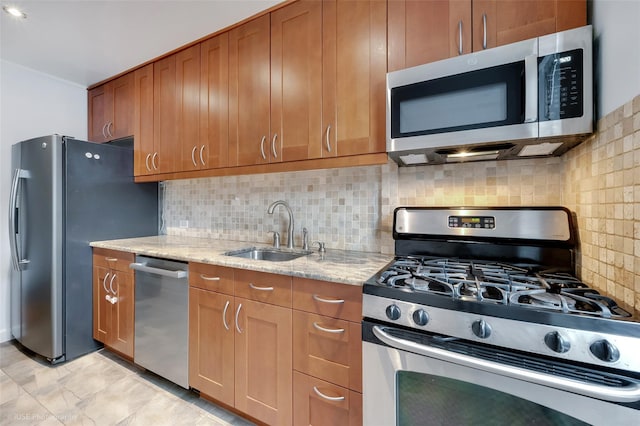 39-60 52nd St Unit 4F, Woodside, NY 11377 - kitchen with appliances with stainless steel finishes, brown cabinetry, light stone countertops, and decorative backsplash