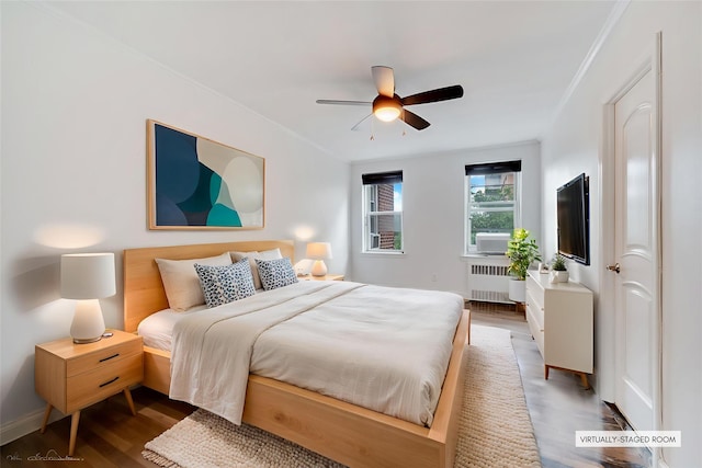 39-60 52nd St Unit 4F, Woodside, NY 11377 - bedroom with radiator, wood finished floors, a ceiling fan, and crown molding