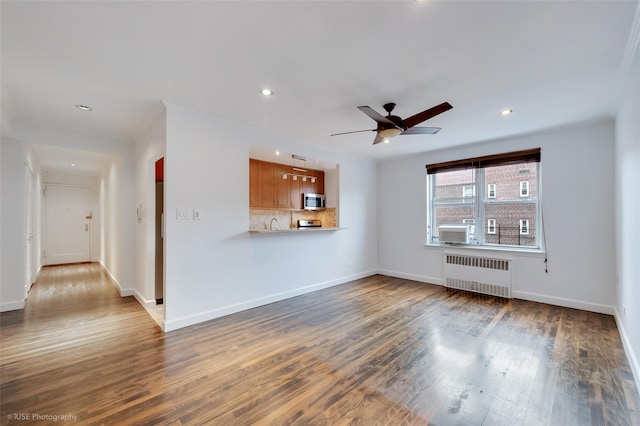39-60 52nd St Unit 4F, Woodside, NY 11377 - unfurnished living room with radiator heating unit, a ceiling fan, wood finished floors, and recessed lighting