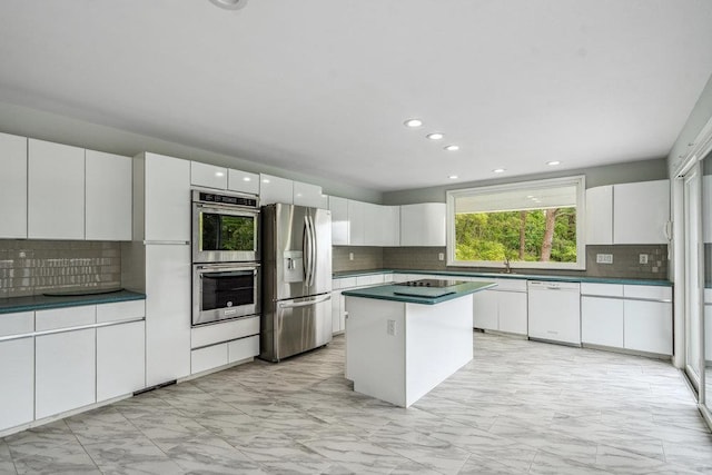 542 Montauk Hwy, Southampton, NY 11968 - kitchen with stainless steel appliances, light marble finish floors, backsplash, and recessed lighting