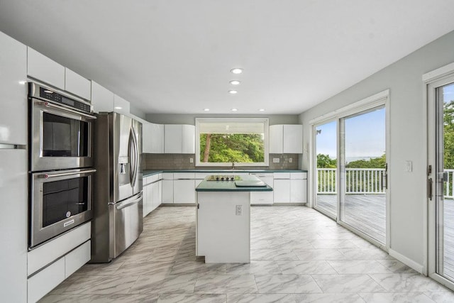 542 Montauk Hwy, Southampton, NY 11968 - kitchen featuring stainless steel appliances, light marble finish floors, a kitchen island, healthy amount of natural light, and recessed lighting