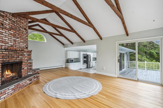 542 Montauk Hwy, Southampton, NY 11968 - unfurnished living room with a baseboard radiator, high vaulted ceiling, light wood finished floors, a brick fireplace, and beamed ceiling