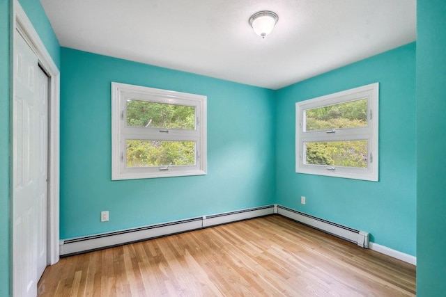 542 Montauk Hwy, Southampton, NY 11968 - unfurnished room featuring a baseboard radiator and wood finished floors