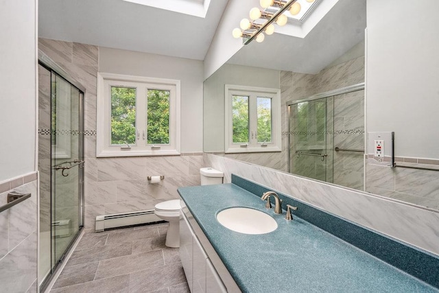 542 Montauk Hwy, Southampton, NY 11968 - bathroom with a baseboard radiator, tile walls, healthy amount of natural light, a skylight, and a stall shower