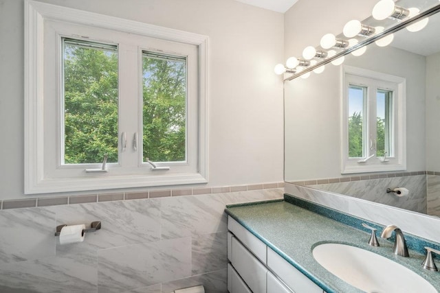542 Montauk Hwy, Southampton, NY 11968 - bathroom featuring vanity, tile walls, plenty of natural light, and wainscoting
