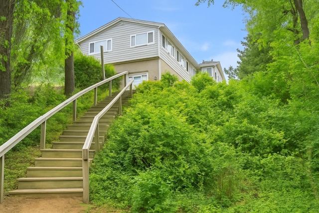 542 Montauk Hwy, Southampton, NY 11968 - back of house featuring stairway and stucco siding