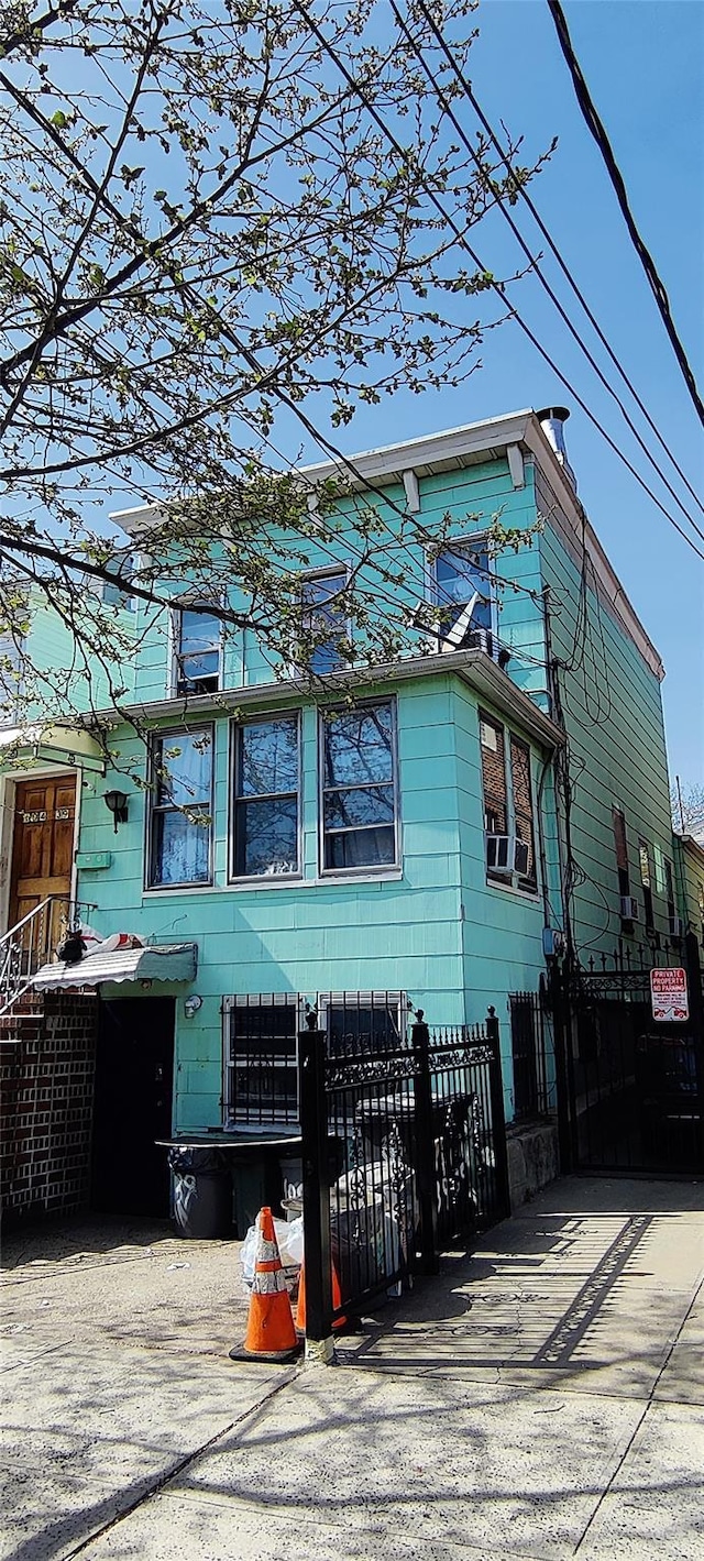 10439 42nd Ave, Corona, NY 11368 - view of front of home featuring a fenced front yard and cooling unit