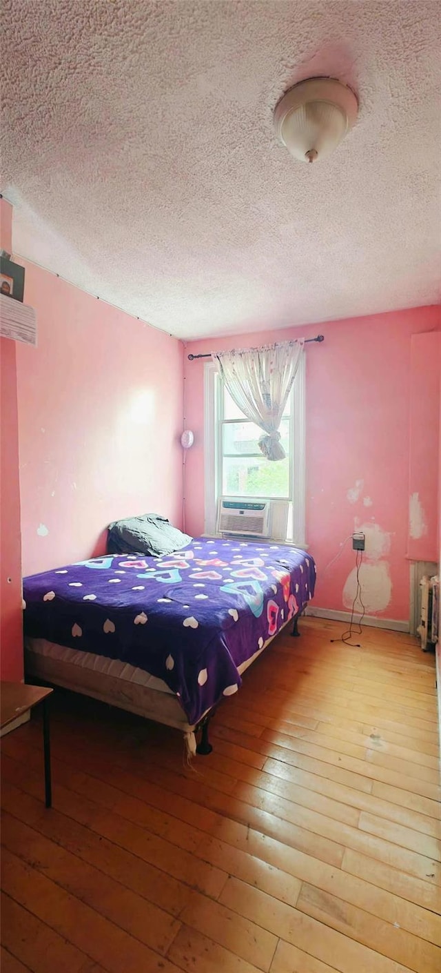 10439 42nd Ave, Corona, NY 11368 - bedroom with a textured ceiling, hardwood / wood-style flooring, and cooling unit